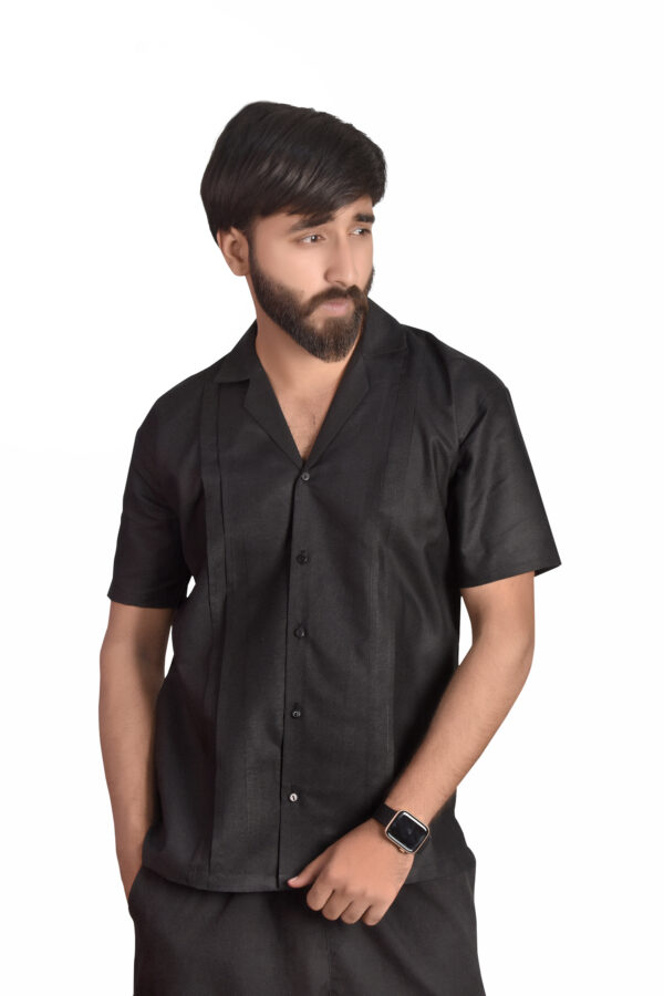 A model wearing black cuban collar shirt, white background